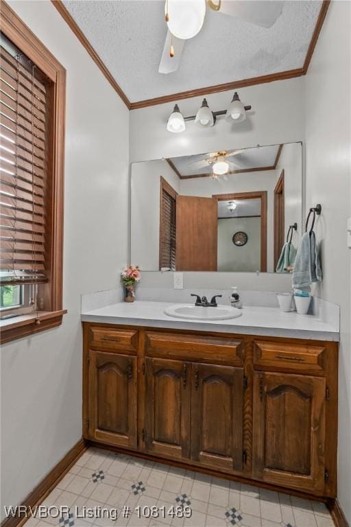 2650 Spielerville Rd, Paris, AR 72855 - bathroom with a ceiling fan, ornamental molding, vanity, baseboards, and tile patterned floors