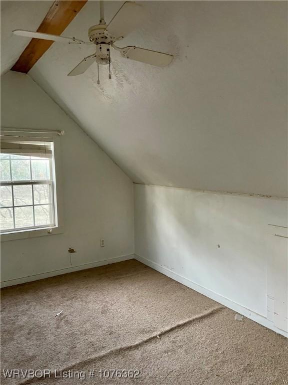 additional living space featuring carpet flooring, ceiling fan, and lofted ceiling