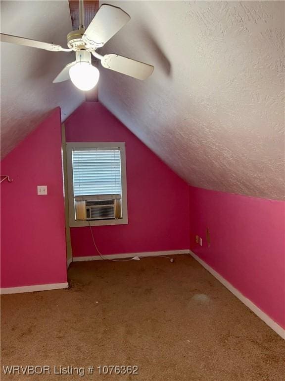 additional living space with ceiling fan, carpet floors, cooling unit, a textured ceiling, and vaulted ceiling