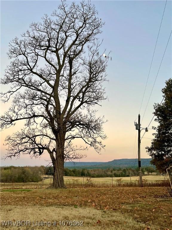 nature at dusk featuring a rural view