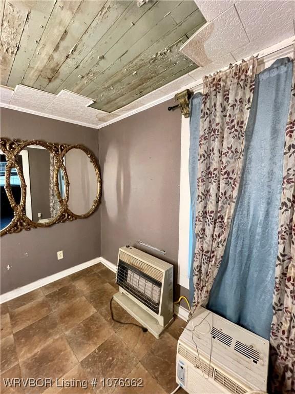 interior space featuring heating unit and wooden ceiling