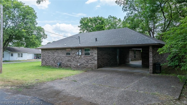 view of side of property featuring a yard and a carport