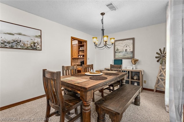 carpeted dining room featuring a textured ceiling and a notable chandelier