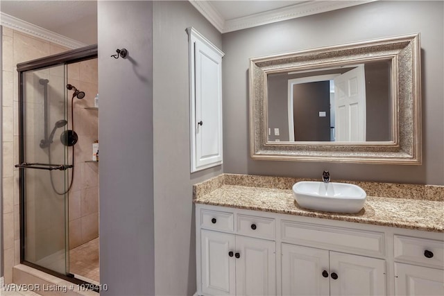 bathroom featuring a stall shower, vanity, and ornamental molding