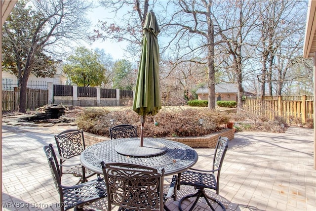 view of patio / terrace featuring outdoor dining space and fence private yard