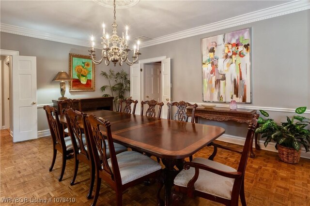 dining area featuring a notable chandelier, crown molding, and baseboards