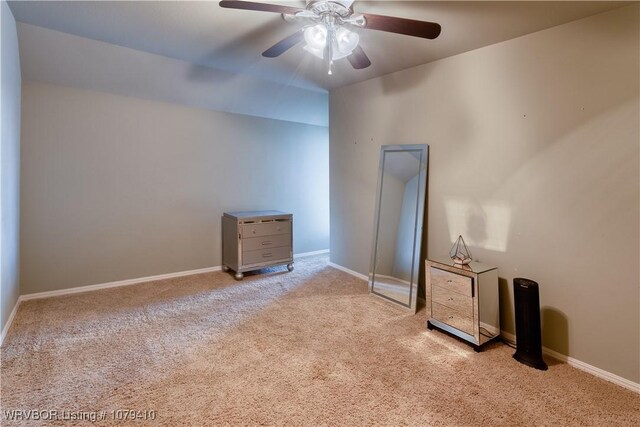 unfurnished room with ceiling fan, baseboards, and carpet