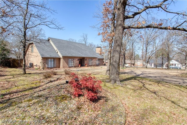 view of front of home featuring fence and a chimney