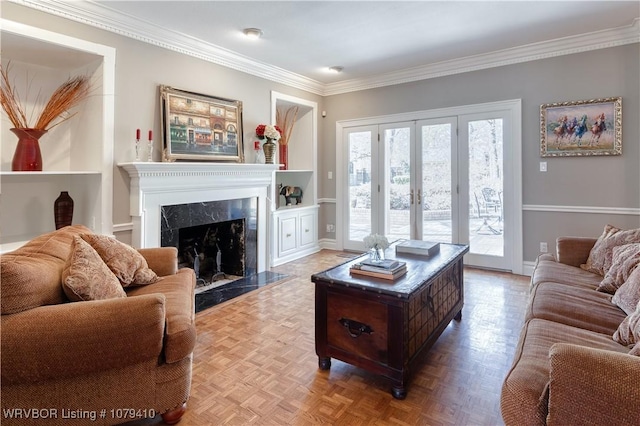 living room with a fireplace, a healthy amount of sunlight, baseboards, and ornamental molding