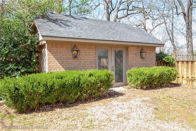 view of outbuilding featuring fence