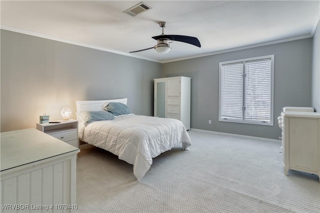 bedroom featuring light carpet, baseboards, visible vents, and ornamental molding