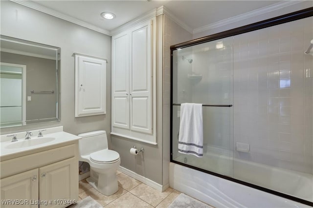 bathroom featuring tile patterned flooring, crown molding, toilet, shower / bath combination with glass door, and vanity