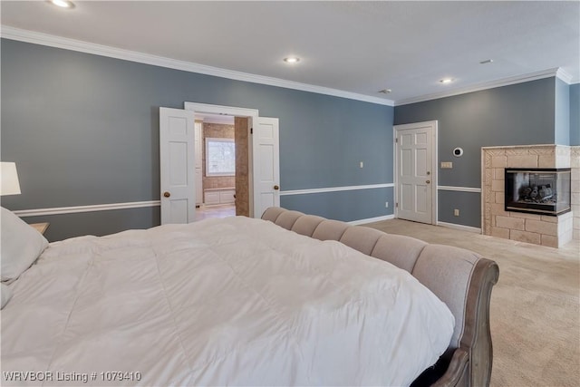 carpeted bedroom with ornamental molding, recessed lighting, baseboards, and a tile fireplace