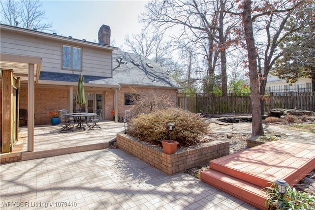 deck with outdoor dining space and fence