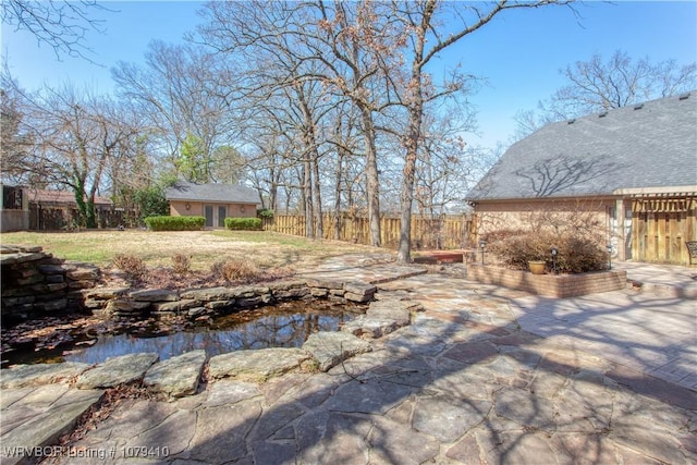 view of yard with a patio area, fence private yard, and an outbuilding