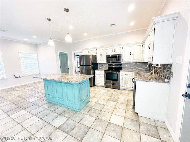 kitchen with a center island, sink, stainless steel appliances, pendant lighting, and white cabinets