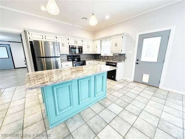 kitchen with light stone countertops, black appliances, white cabinets, a kitchen island, and hanging light fixtures