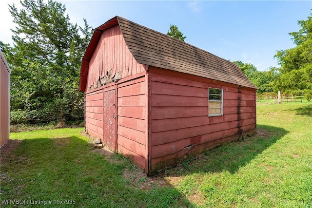 view of outbuilding featuring a lawn