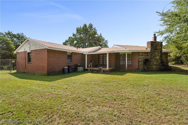 rear view of house with a yard