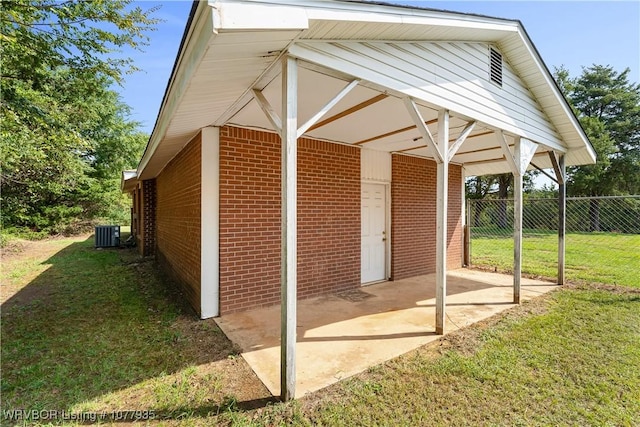 view of outbuilding with a yard and central air condition unit