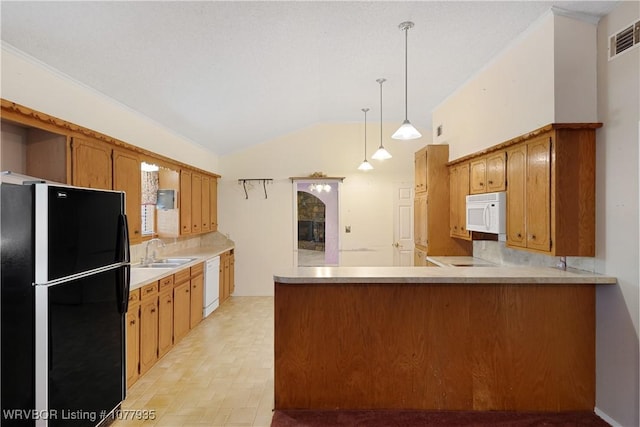 kitchen with white appliances, sink, vaulted ceiling, decorative light fixtures, and kitchen peninsula