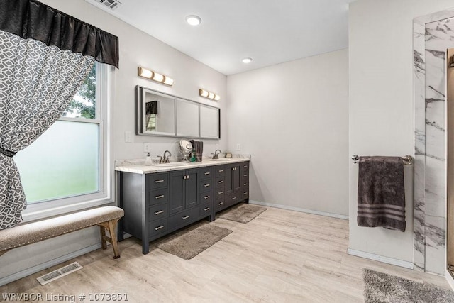 2055 Barber Rd, Booneville, AR 72927 - bathroom featuring double vanity, recessed lighting, and wood finished floors
