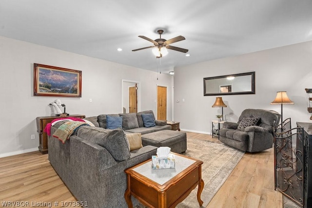 living room featuring light hardwood / wood-style floors and ceiling fan