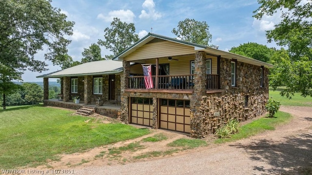 2055 Barber Rd, Booneville, AR 72927 - view of front facade featuring stone siding, dirt driveway, a front lawn, and a balcony