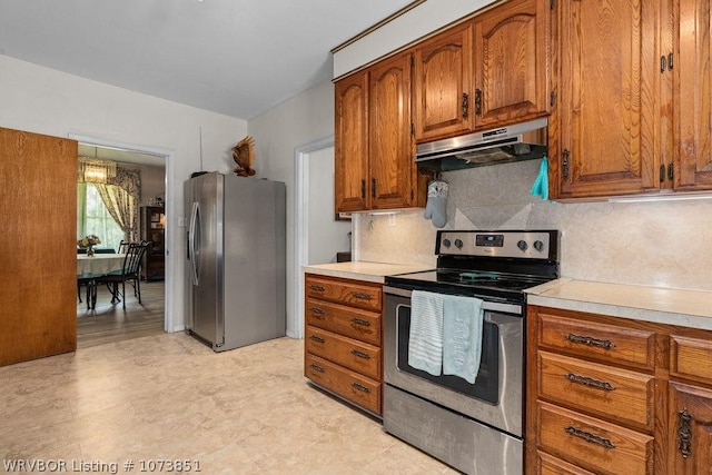 2055 Barber Rd, Booneville, AR 72927 - kitchen with appliances with stainless steel finishes, under cabinet range hood, light countertops, and brown cabinets