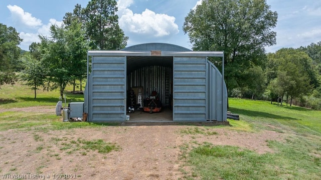 view of outbuilding featuring a lawn