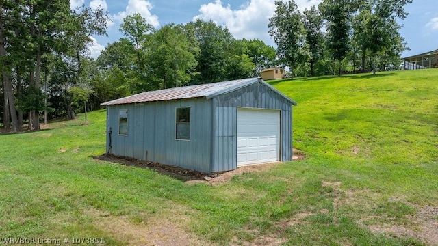 view of outdoor structure with a yard and a garage