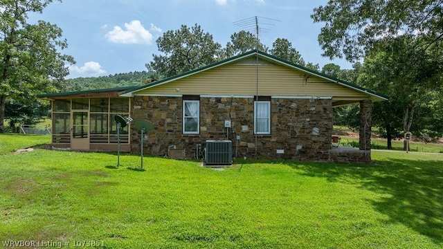 2055 Barber Rd, Booneville, AR 72927 - back of property featuring a sunroom, stone siding, and a yard
