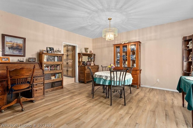 dining area featuring a chandelier and light hardwood / wood-style flooring