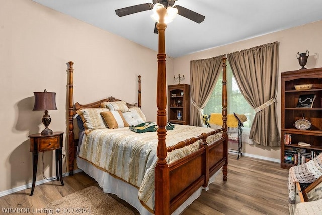 bedroom with ceiling fan and wood-type flooring