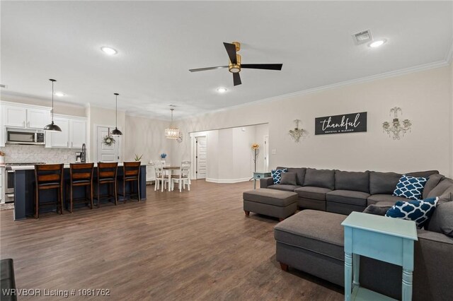8323 Mclaren Dr, Fort Smith, AR 72916 - living area featuring ceiling fan, ornamental molding, dark wood-style flooring, and recessed lighting