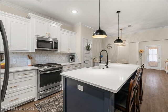 8323 Mclaren Dr, Fort Smith, AR 72916 - kitchen with stainless steel appliances, decorative backsplash, white cabinetry, light countertops, and dark wood-type flooring