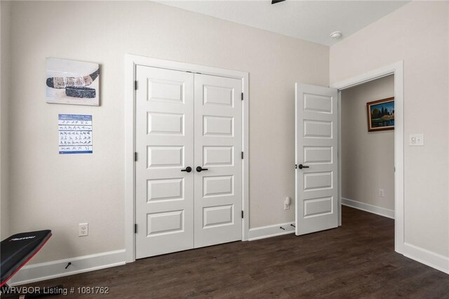 8323 Mclaren Dr, Fort Smith, AR 72916 - unfurnished bedroom with dark wood-style flooring and a closet