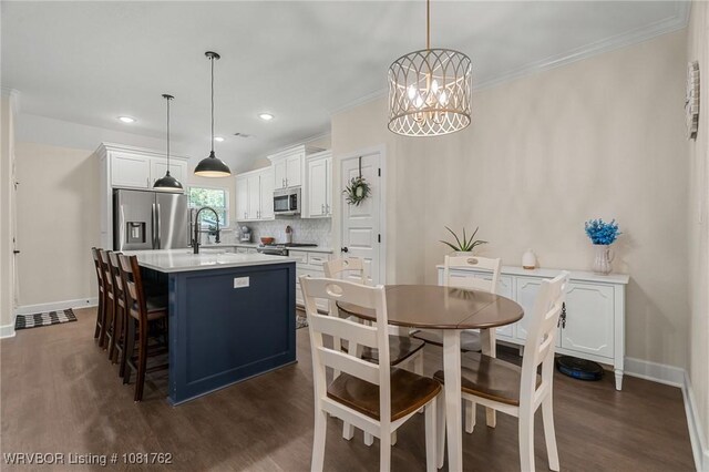 8323 Mclaren Dr, Fort Smith, AR 72916 - dining area featuring dark wood-style flooring, a chandelier, crown molding, and recessed lighting