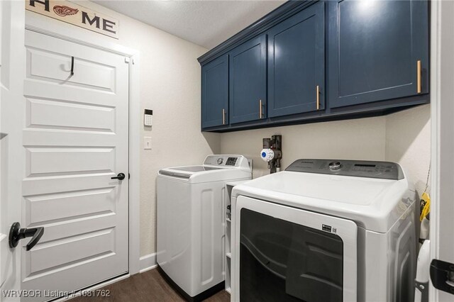 8323 Mclaren Dr, Fort Smith, AR 72916 - washroom with washer and dryer, cabinet space, and dark wood-style flooring