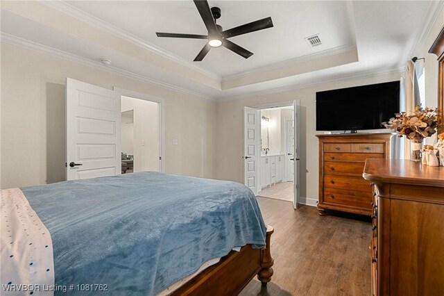 8323 Mclaren Dr, Fort Smith, AR 72916 - bedroom with a tray ceiling, dark wood-type flooring, crown molding, ensuite bathroom, and ceiling fan