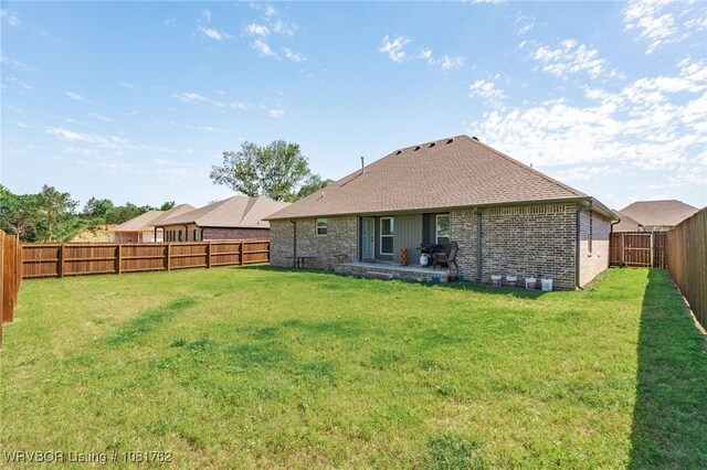 8323 Mclaren Dr, Fort Smith, AR 72916 - back of house featuring a fenced backyard, brick siding, a patio, and roof with shingles