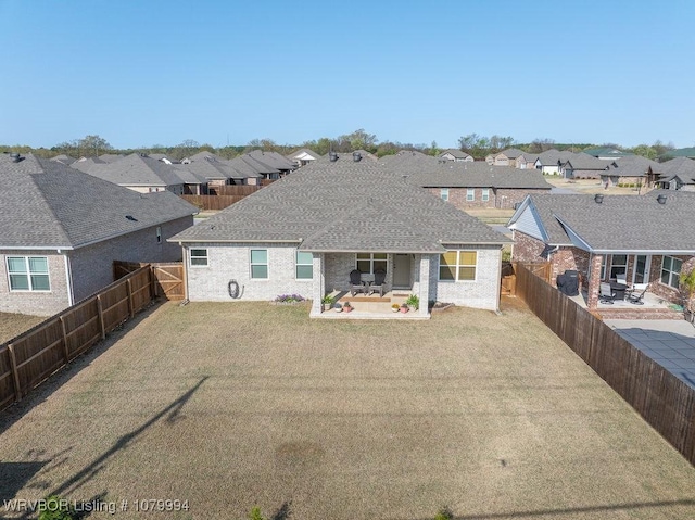 7907 Coltridge Way, Fort Smith, AR 72916 - rear view of house featuring a fenced backyard, a lawn, a residential view, and a patio