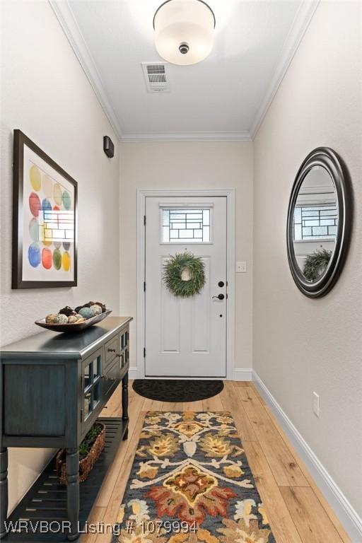 7907 Coltridge Way, Fort Smith, AR 72916 - entrance foyer with light wood-style flooring, ornamental molding, baseboards, and visible vents