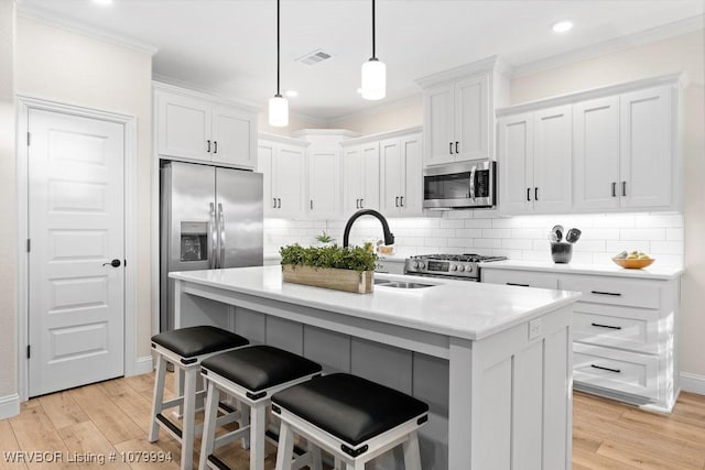 7907 Coltridge Way, Fort Smith, AR 72916 - kitchen featuring white cabinetry, stainless steel appliances, crown molding, and light wood-type flooring