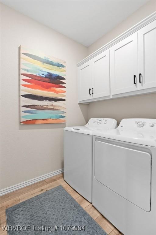 7907 Coltridge Way, Fort Smith, AR 72916 - washroom featuring washing machine and clothes dryer, cabinet space, light wood-style flooring, and baseboards