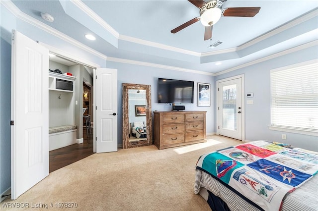 bedroom featuring ceiling fan, a raised ceiling, light carpet, and crown molding