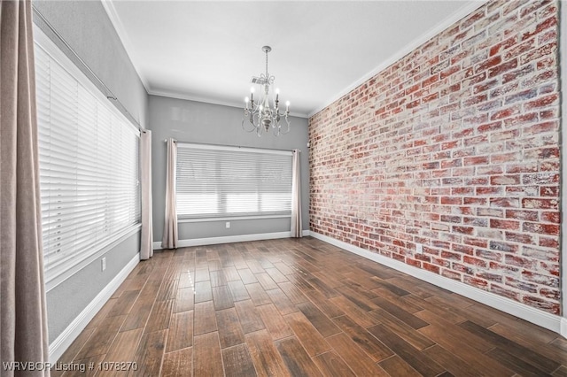 unfurnished room featuring ornamental molding, dark wood-type flooring, brick wall, and a chandelier