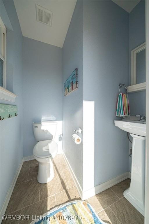 bathroom with tile patterned floors and toilet