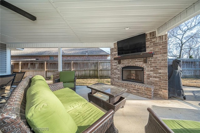 view of patio / terrace with an outdoor living space with a fireplace