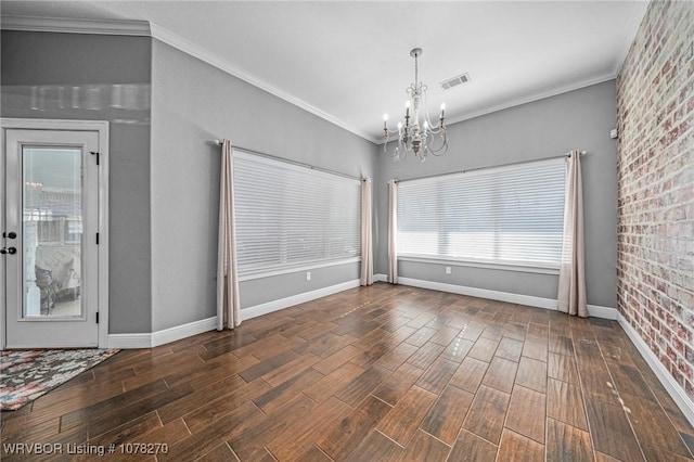 unfurnished dining area featuring crown molding and a chandelier